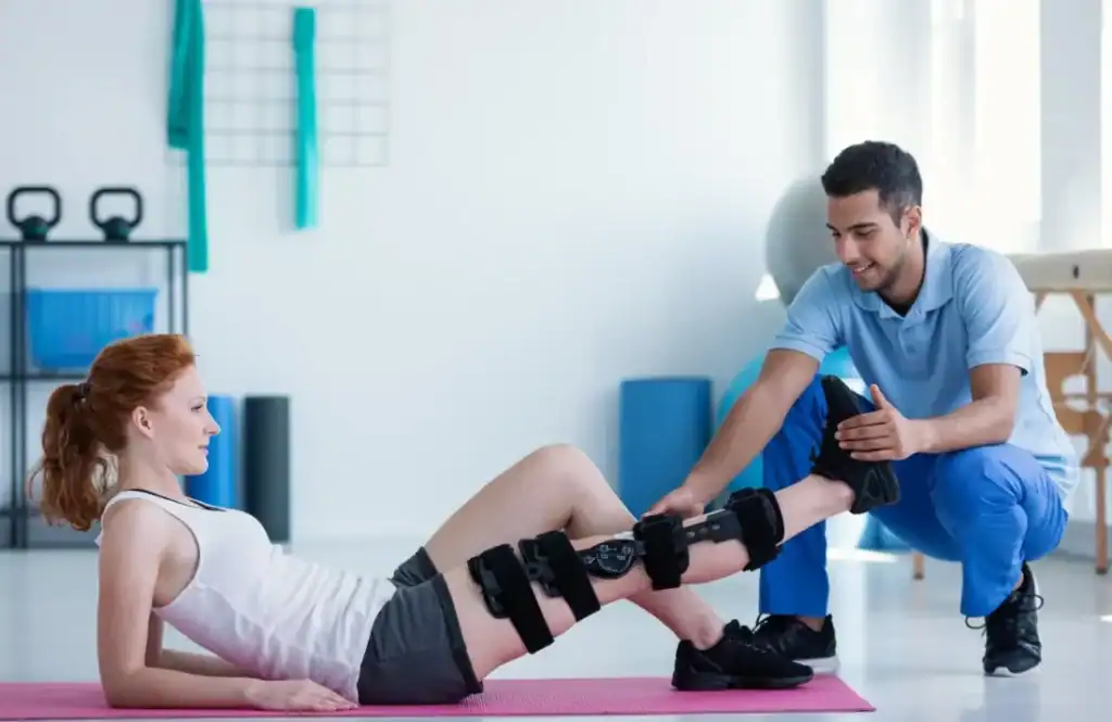 Woman having treatment to help muscle recovery Llanelli after an injury